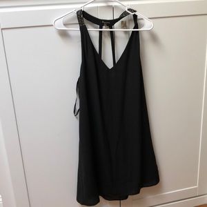 Black dress with beads on the straps.